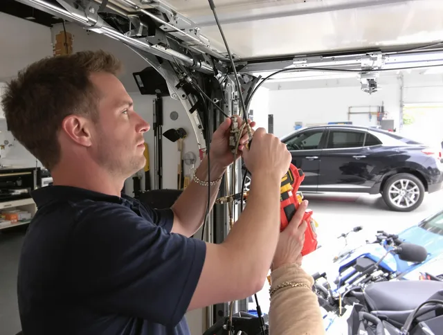Streetsboro Garage Door Repair safety certified technician performing cable replacement in Streetsboro